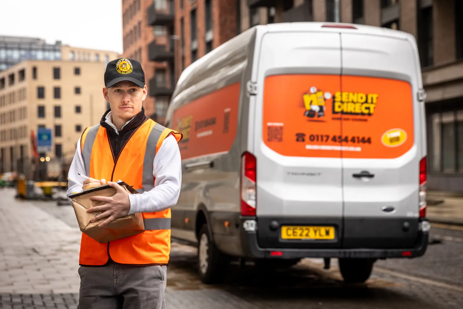 Courier driver carefully holding a package for white glove delivery