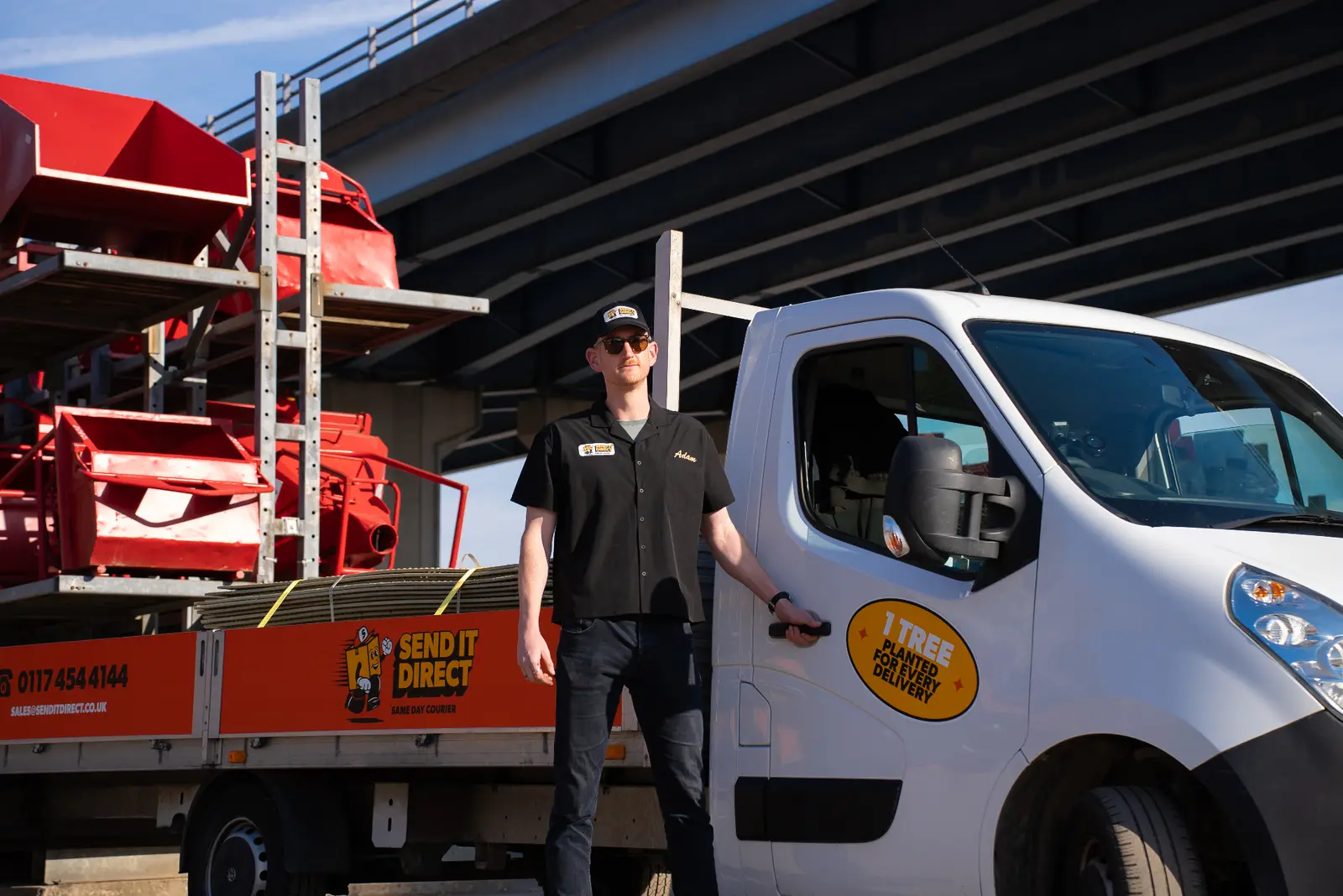 Send It Direct courier driver standing next to branded delivery van
