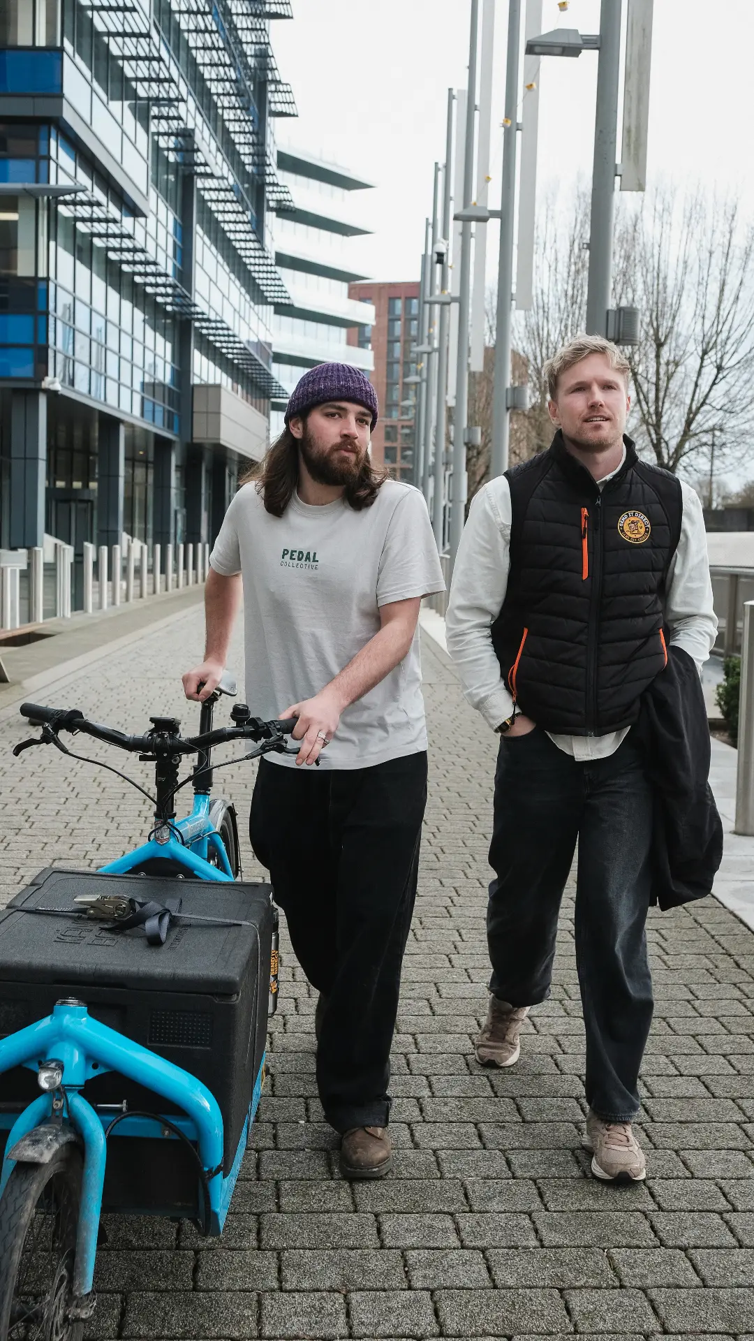 Send It Direct and Pedal Collective team walking with cargo bike in Bristol